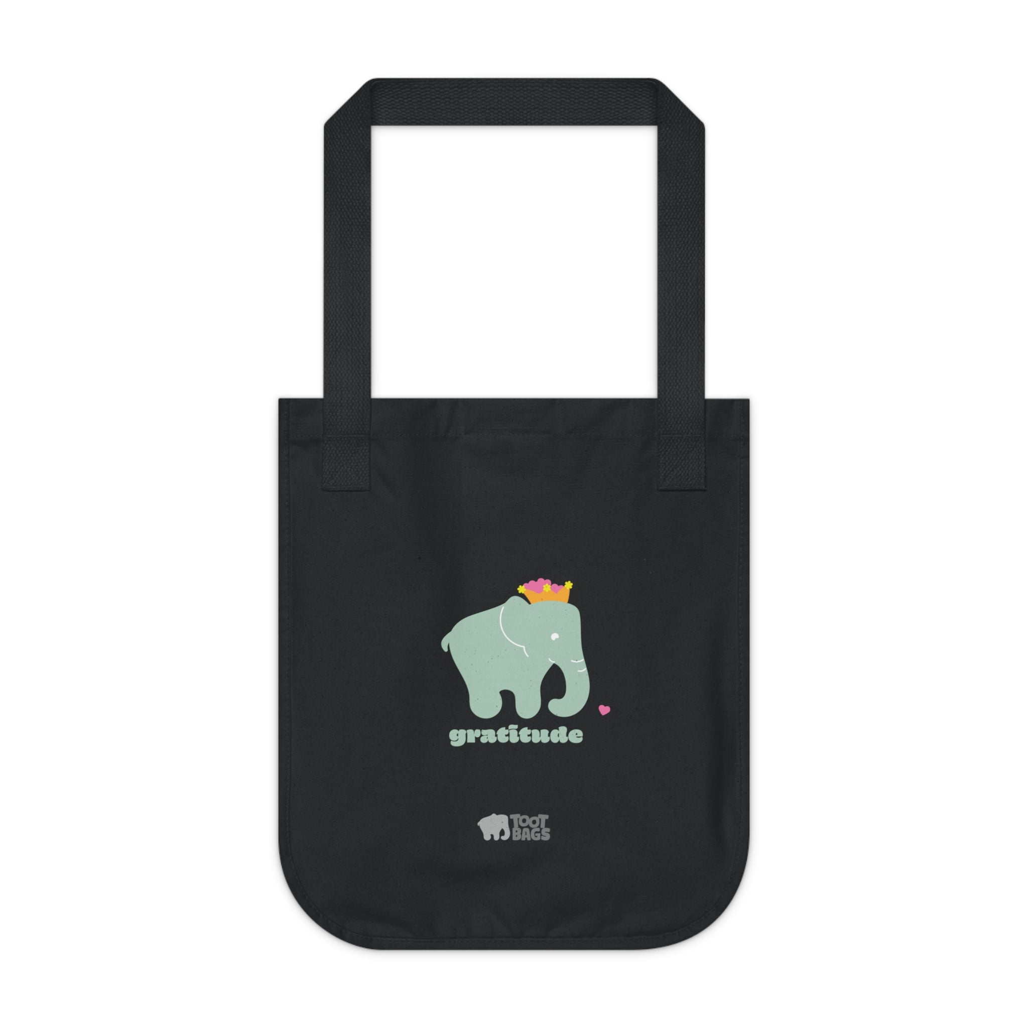 Black canvas tote bag featuring a printed matcha color elephant and 'gratitude' text with colorful hearts on a white background.