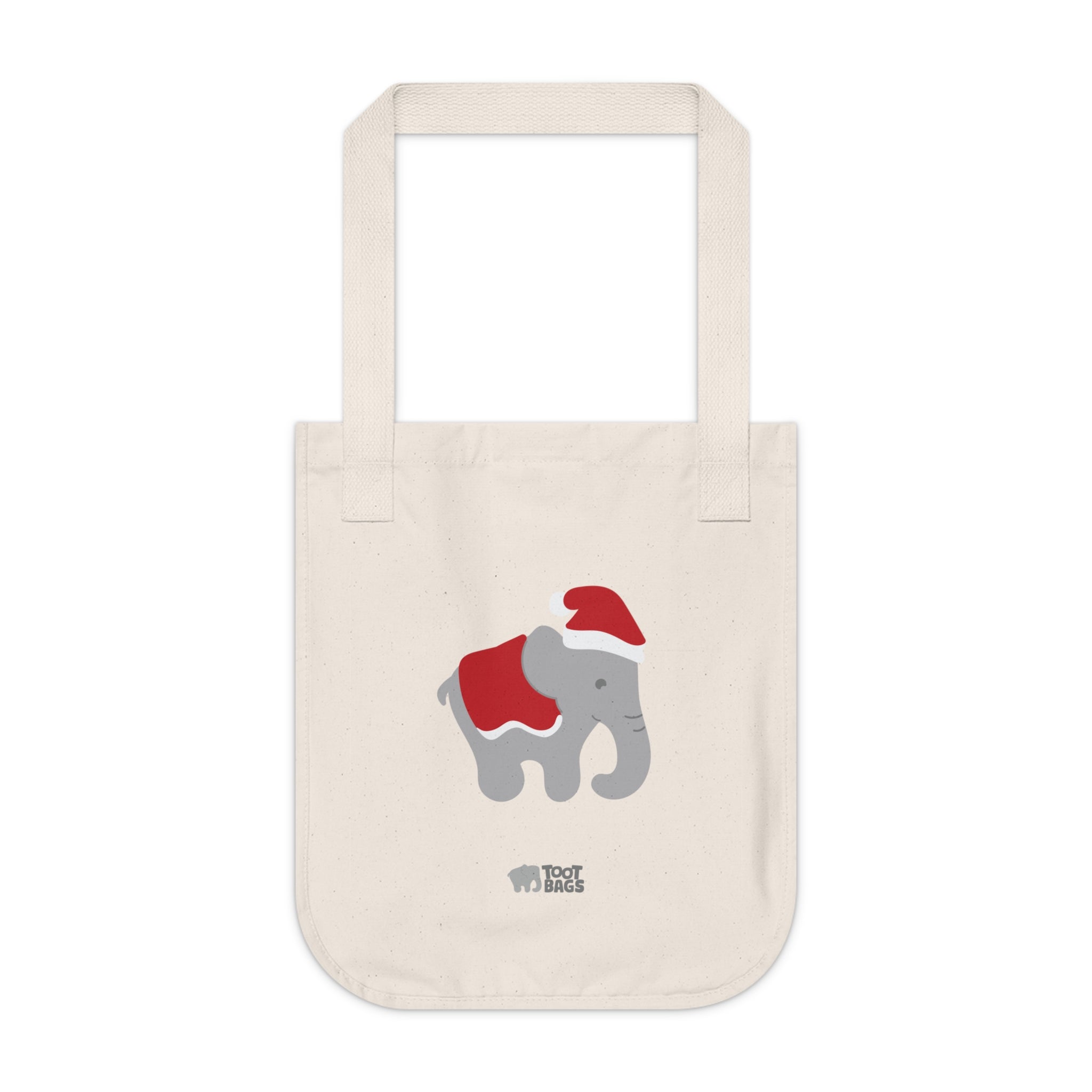 Natural canvas tote bag with printed graphics - a gray elephant wearing a red christmas hat and a red blanket on a white background.