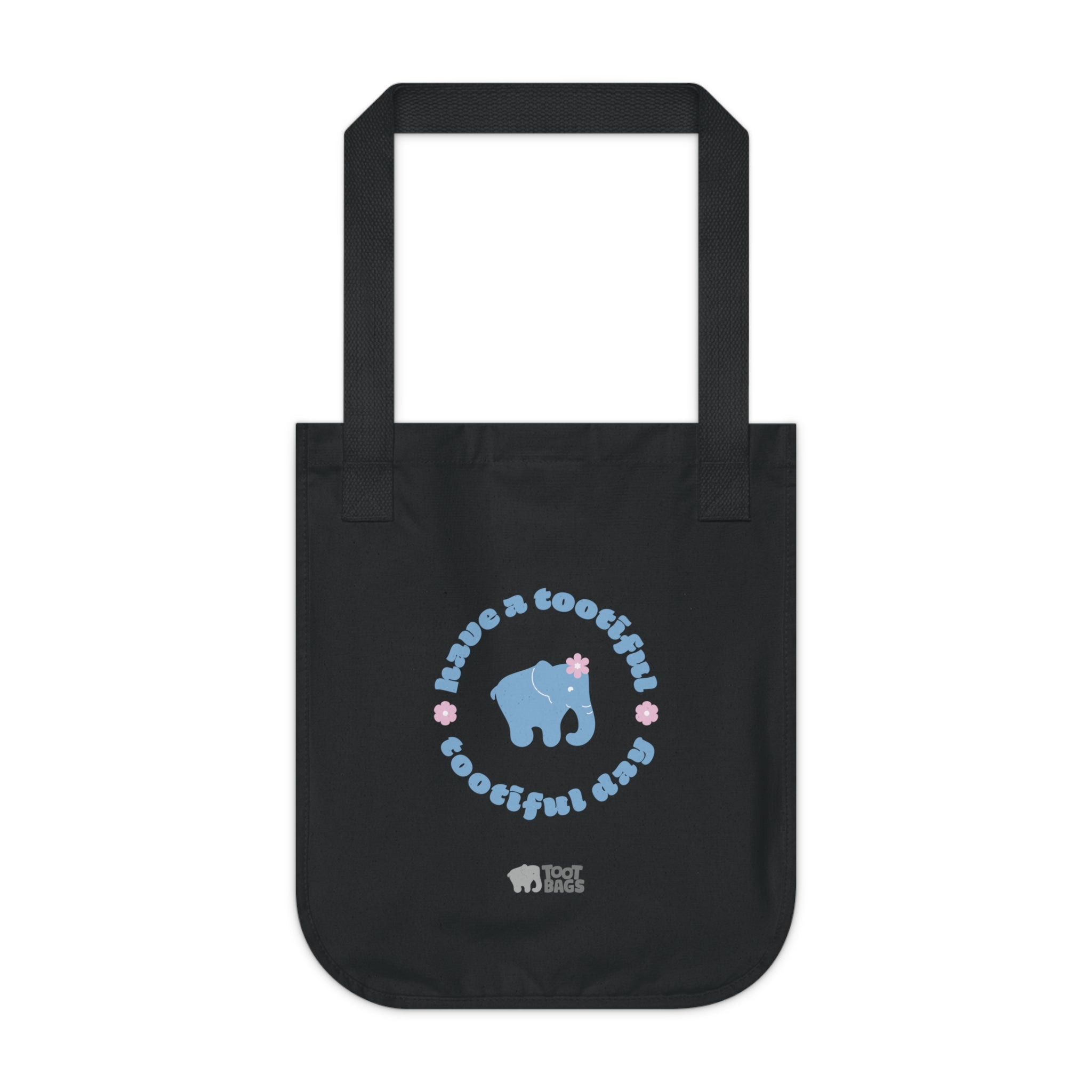 Black canvas tote bag with printed design featuring a blue elephant and 'have a tootiful tootiful day’ text with pink floral design on a a white background.