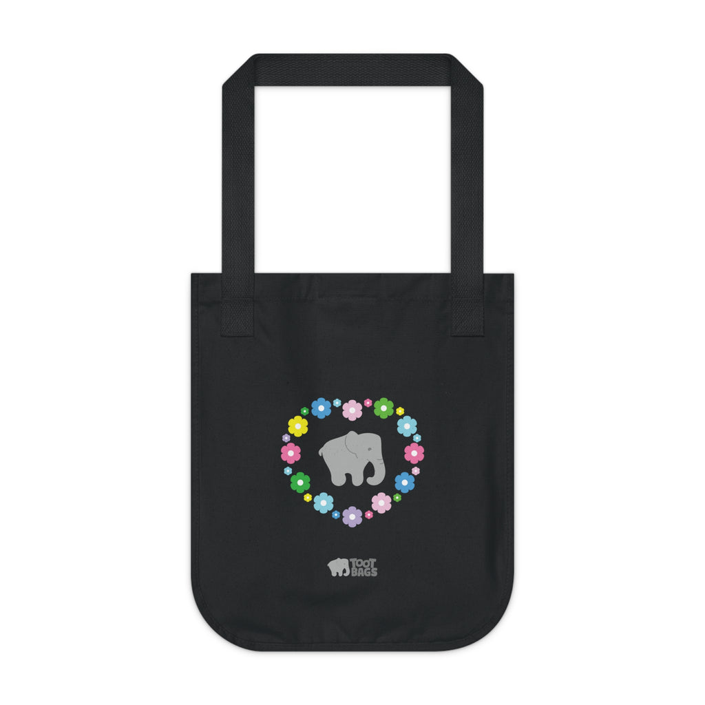 Black canvas tote bag with a printed heart design featuring a gray elephant and colorful flowers on a white background.