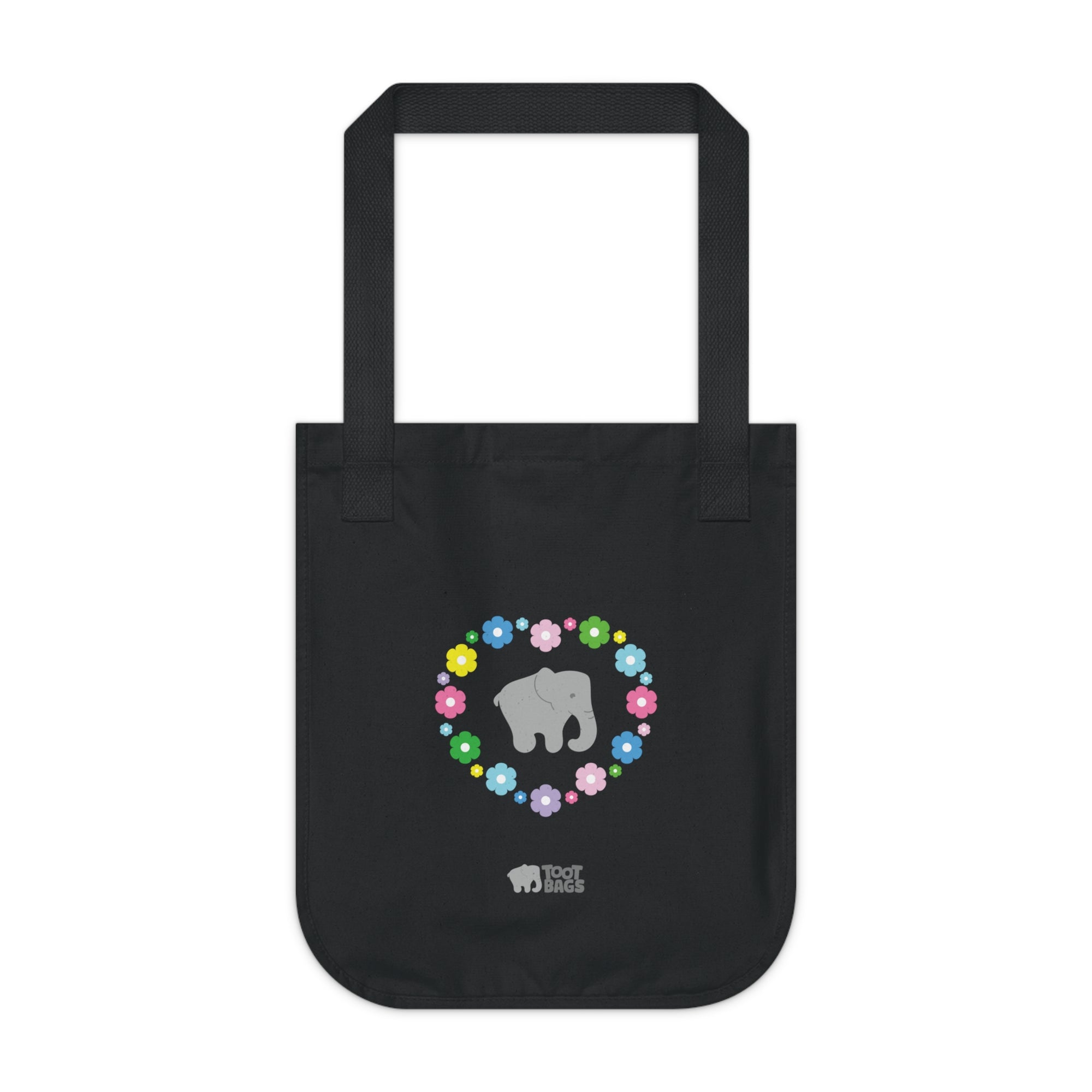 Black canvas tote bag with a printed heart design featuring a gray elephant and colorful flowers on a white background.