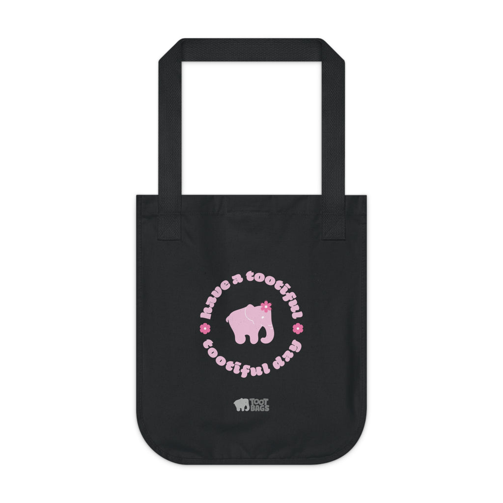 Black canvas tote bag with a pink elephant and text with pink flowers on a white background.