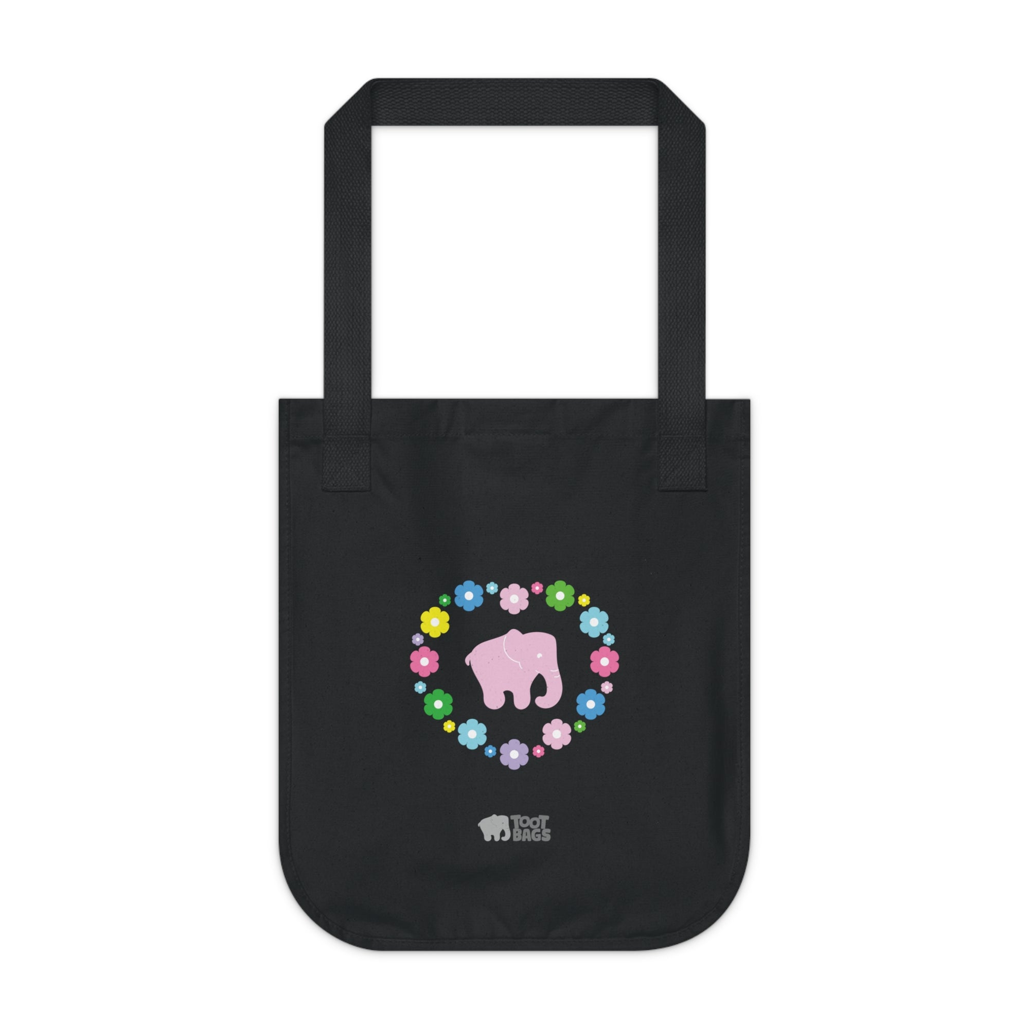 Black canvas tote bag with a printed heart design featuring a pink elephant and colorful flowers on a white background.