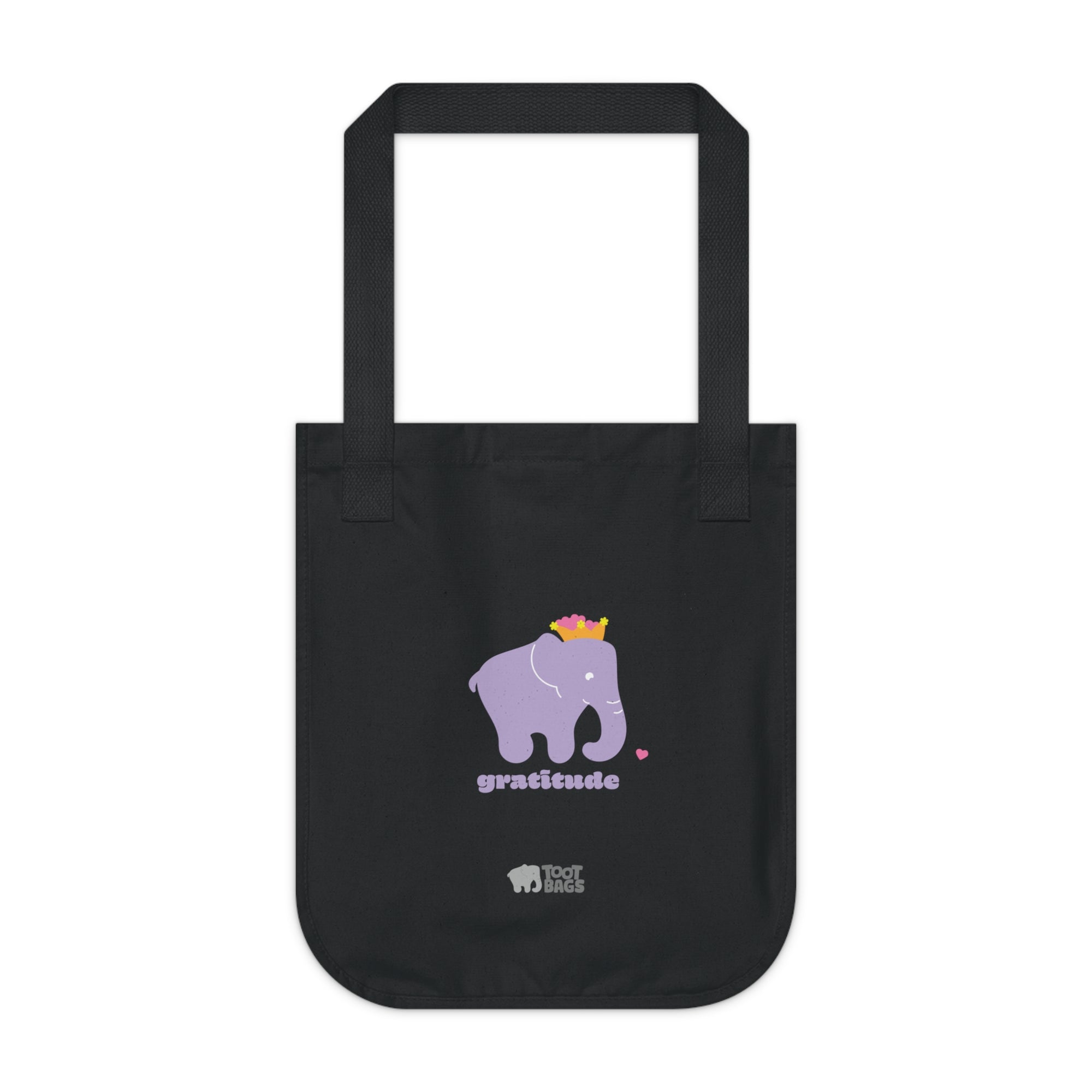 Black canvas tote bag featuring a printed design; a purple elephant, purple 'gratitude' text and colorful hearts on a white background.