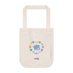 Natural beige canvas tote bag featuring a colorful printed design; a blue elephant with floral heart shaped design on a white background.  