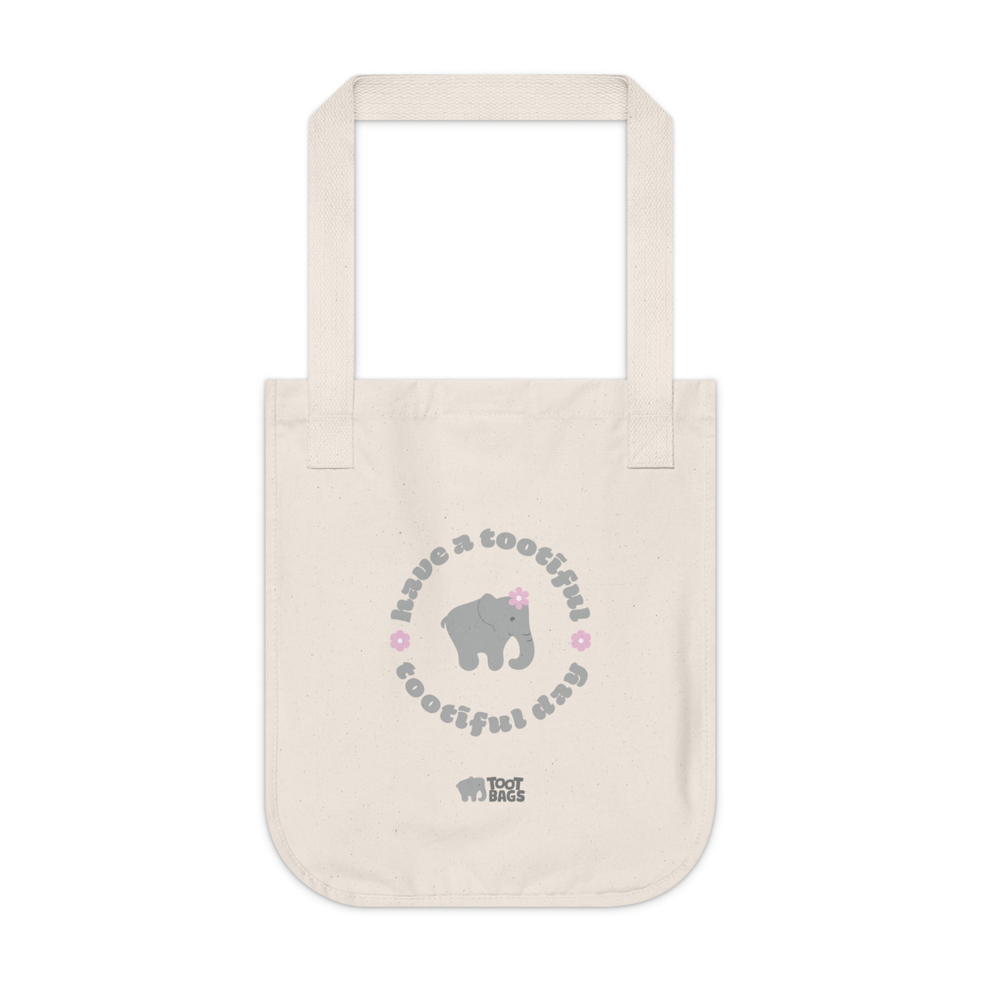 Natural beige canvas tote bag with printed design featuring a gray elephant, gray 'have a tootiful tootiful day’ text with pink floral design on a white background.
