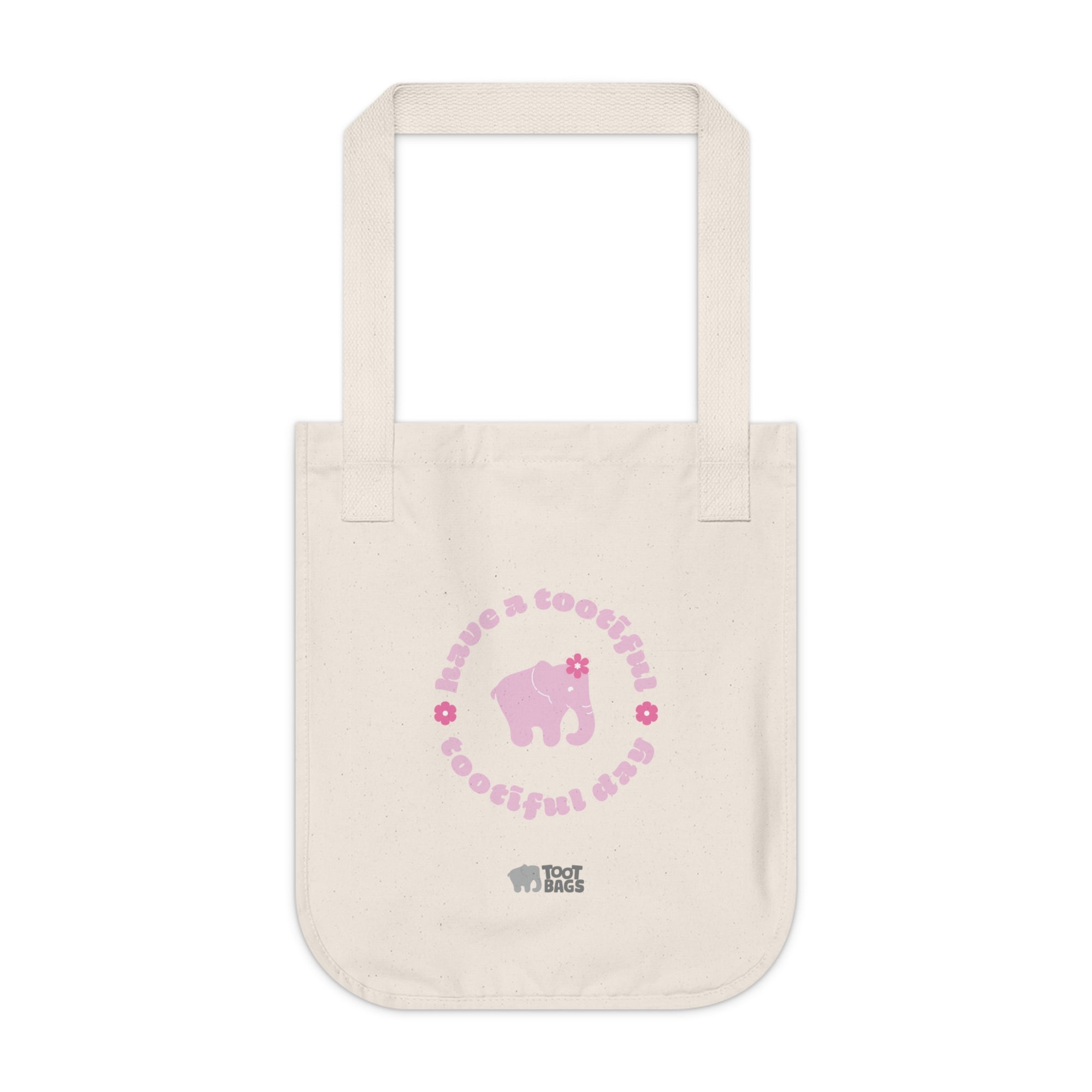 Natural beige canvas tote bag with printed design featuring a pink elephant, pink 'have a tootiful tootiful day’ text with colorful pink flowers on a white background.