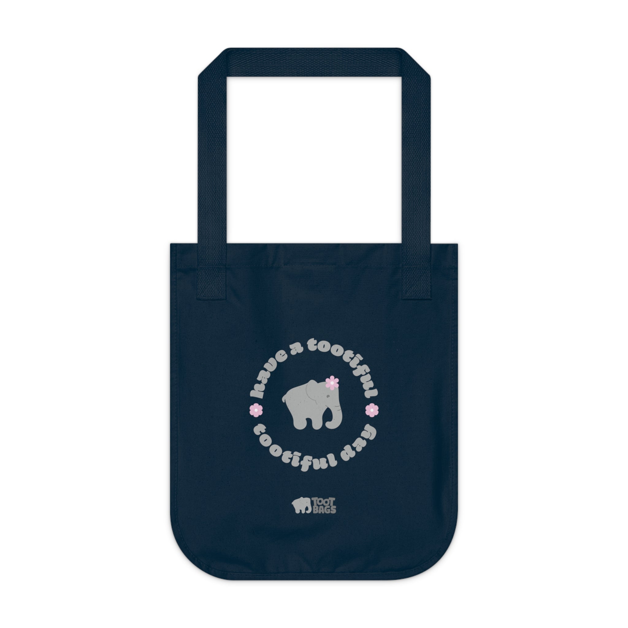 Navy blue canvas tote bag with printed design featuring a gray elephant, gray 'have a tootiful tootiful day’ text with pink floral design on a white background.