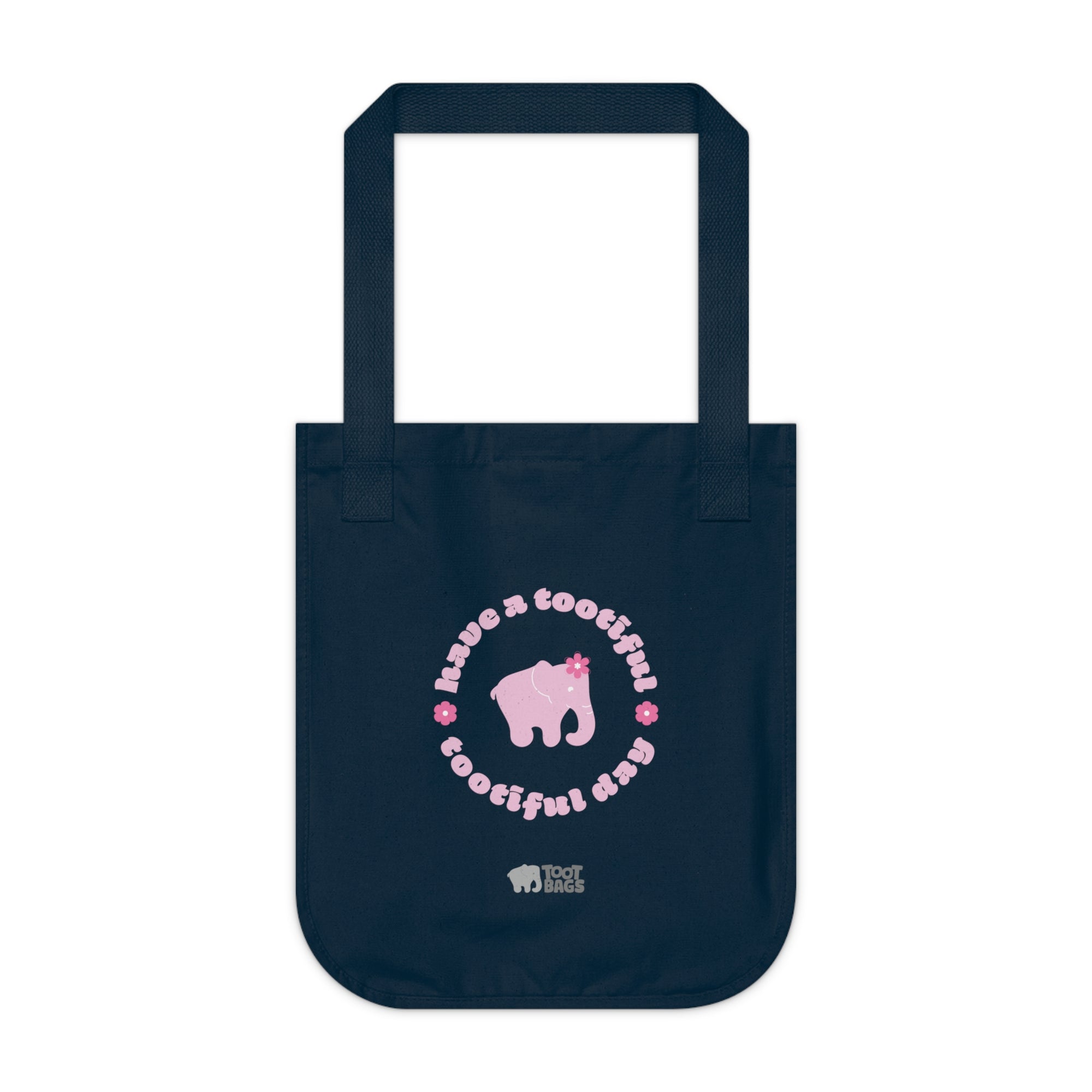 Navy blue canvas tote bag with printed design featuring a pink elephant, 'have a tootiful tootiful day’ text with colorful pink flowers on a white background.